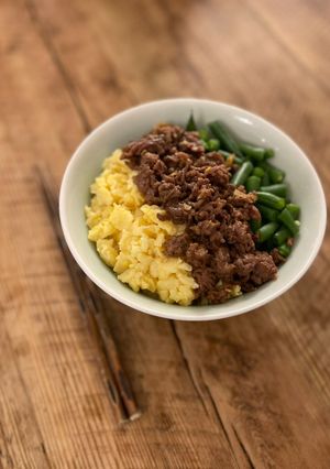 A picture of 🍚 Tricolor Donburi - Japanese bowl of rice with minced meat, eggs and green vegetable.