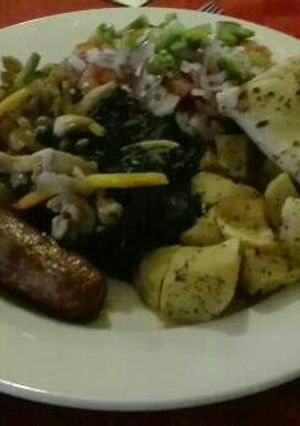 A picture of African breakfast sausages, pancakes, salad with kachumbari.