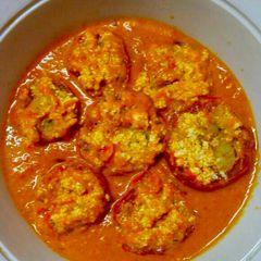 A picture of Paneer Stuffed Tomato in red greavy.