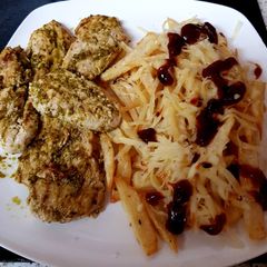 A picture of My Grilled Chicken with Pesto sauce and cheesy chips. 😙.
