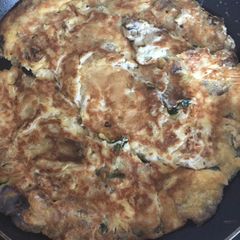 A picture of Mushroom Omelette with fresh Coriander and Butter.