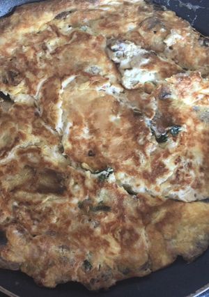 A picture of Mushroom Omelette with fresh Coriander and Butter.