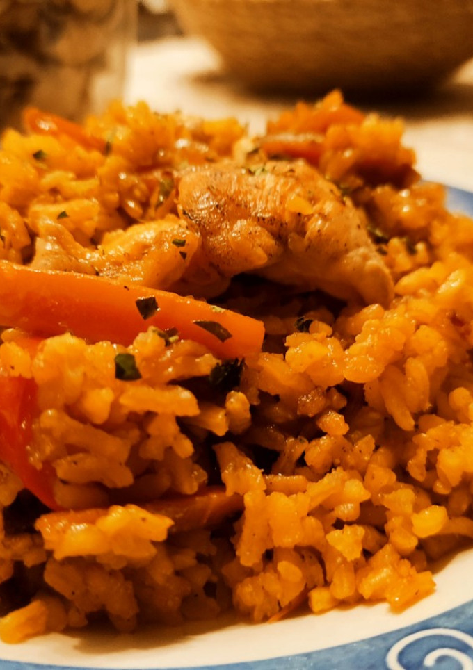 Una foto de Arroz al wok con alitas de pollo y con cebolla, zanahoria y pimientos a la mantequilla y yakiniku