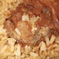 A picture of Jollof rice and chicken.