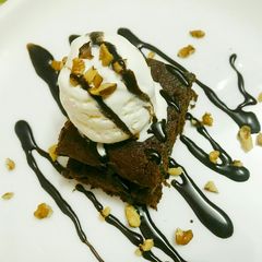A picture of Walnut brownie with ice cream.