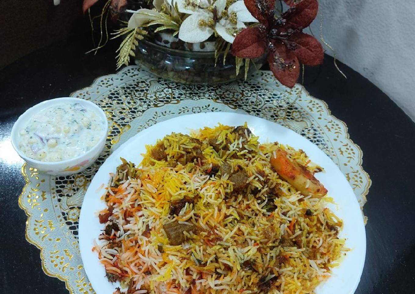 Mutton biryani with boondi and onion cucumber raita
