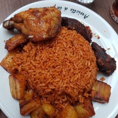 A picture of Jollof rice,fried plantain and chicken.