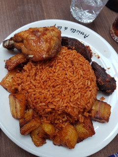 A picture of Jollof rice,fried plantain and chicken.