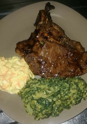 A picture of Grilled Beef steak, Creamed Spinach with coselaw.