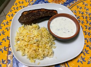 Une photo de Aubergine rôtie au miel et épices, sauce yaourt et riz au safran