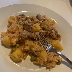 A picture of Rice mixed with beef and peas.