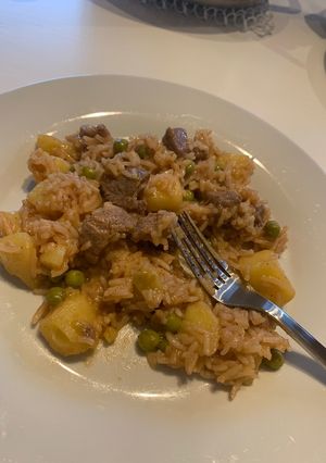 A picture of Rice mixed with beef and peas.