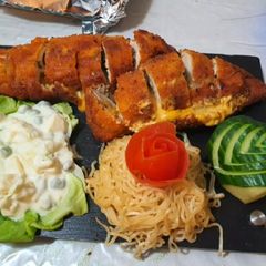 A picture of Chicken Ala kiev with stuffed mushrooms and cheese.