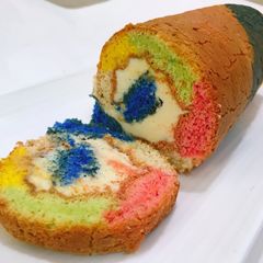 ROLLED FLUFFY RAINBOW CAKE with LEMON BUTTER FROSTING A picture of ROLLED FLUFFY RAINBOW CAKE with LEMON BUTTER FROSTING.
