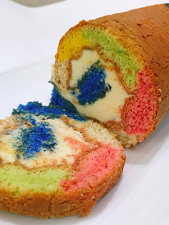 A picture of ROLLED FLUFFY RAINBOW CAKE with LEMON BUTTER FROSTING.