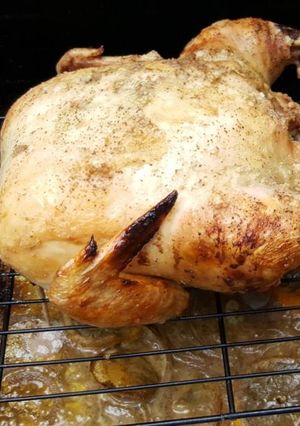 A picture of Whole roasted chicken on the grill.