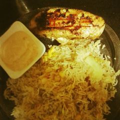 A picture of Peri peri chicken with rice.