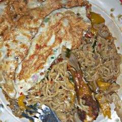 A picture of Noodles with fried egg.