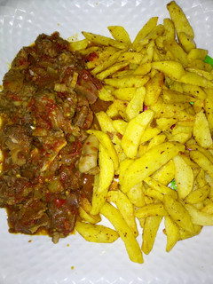 A picture of Fried potatoes with sauce.