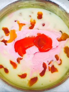 A picture of Dry fruits custard with ice cream.