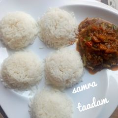 A picture of White rice and veggies sauce.