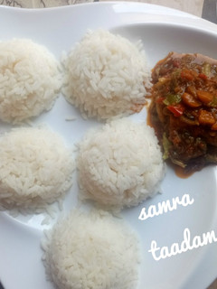 A picture of White rice and veggies sauce.