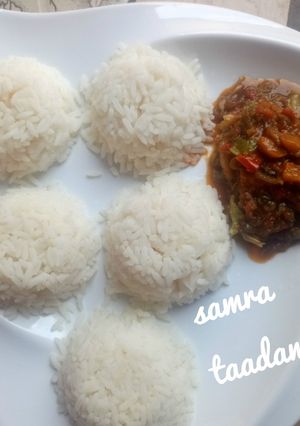 A picture of White rice and veggies sauce.
