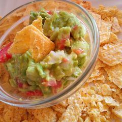 A picture of Tortilla Chips with a Guacamole Dip.