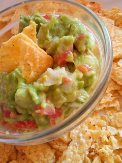 A picture of Tortilla Chips with a Guacamole Dip.