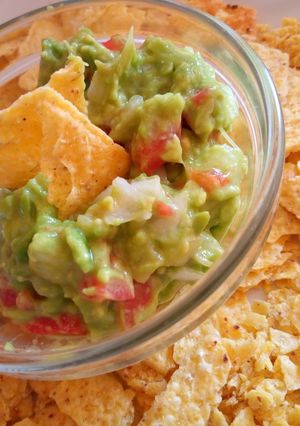 A picture of Tortilla Chips with a Guacamole Dip.