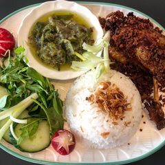Indonesian deep fried duck with green chili sambal and crunchy bits A picture of Indonesian deep fried duck with green chili sambal and crunchy bits.