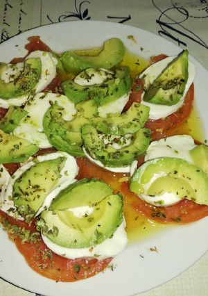 Una foto de Tomate con mozzarella y aguacate ideal para una cena