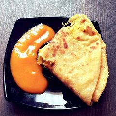 A picture of Puran Poli with Aam Ras.
