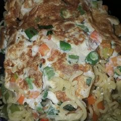 A picture of Noodles and fried egg.