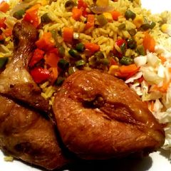 A picture of Jollof rice,fried chicken with coleslaw.