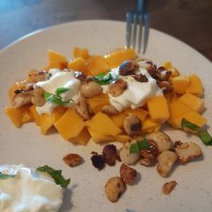 A picture of Mango, caramelized macadamia nuts, and sea salt.