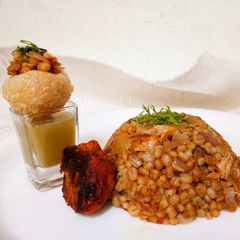 A picture of Amla Murg Barley Khichadi with shots.