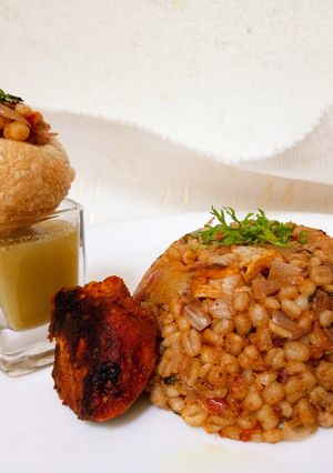 A picture of Amla Murg Barley Khichadi with shots.