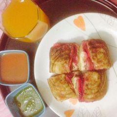 Bombai style cheese veg sandwich with fresh orange juice A picture of Bombai style cheese veg sandwich with fresh orange juice.