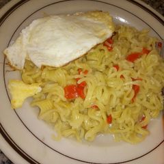 A picture of Noodles with sunny side up egg.