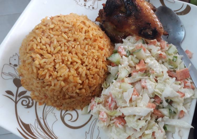 Jollof rice with coleslaw and fried chicken