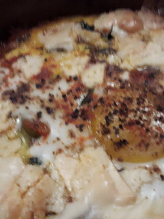 A picture of Tajine Shukshouka with spinach.