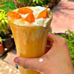 A picture of Ice cream sundae with mango.