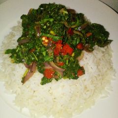 A picture of Steamed white rice with stir fried Green.
