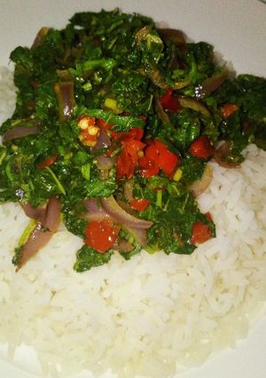 A picture of Steamed white rice with stir fried Green.