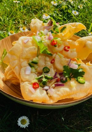 A picture of Loaded Poppadoms / Poppadum Nachos topped with chilli and herbs 🌿🌱.