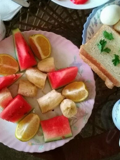 A picture of Bread and eggs with fruits salad.