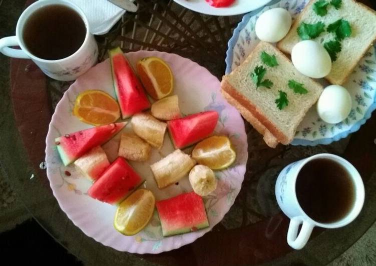 Bread and eggs with fruits salad