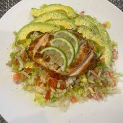 A picture of Chicken breast with green salad.