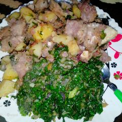 A picture of Fried nduma with beef and potato served. with spinach.